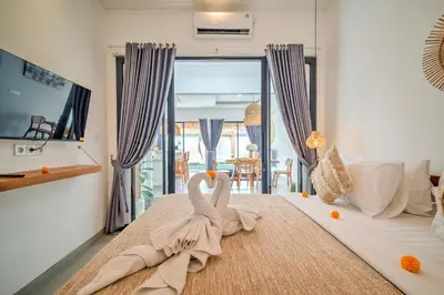 a bedroom with a bed with two swans on it at Villa Esha III in Seminyak
