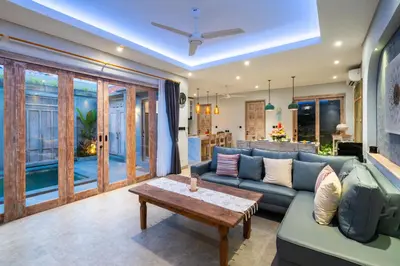 a living room with a couch and a table at Villa Indah in Legian