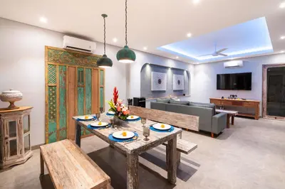 a living room with a table and a couch at Villa Indah in Legian