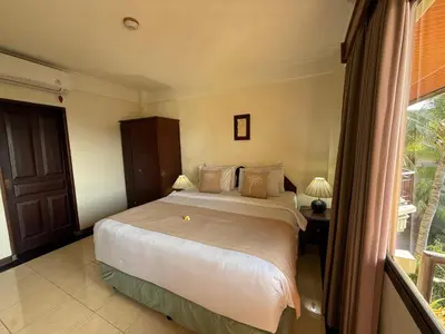a bedroom with a large bed and a window at Private Apartment 6503 at the Jayakarta Residence in Seminyak