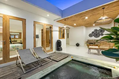 a living room with a pool and two chairs at Spacious 1Br Villas in Seminyak in Seminyak