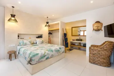 a bedroom with a bed and a chair at Spacious 1Br Villas in Seminyak in Seminyak
