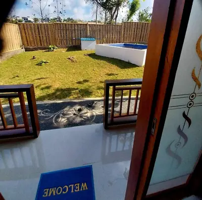 a view of a backyard from a window with a view of a yard at Thula Thula Bali Villas in Kerobokan