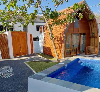 a house with a swimming pool in front of it at Thula Thula Bali Villas in Kerobokan