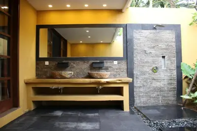 a bathroom with two sinks and a mirror at Alarte Estate by Villa Finder in Seminyak