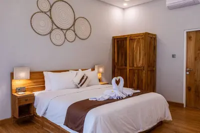 a bedroom with a bed with a towel on it at Villa Cakka Seminyak in Seminyak