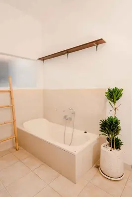a bath tub in a bathroom with a plant at Amazing 2 Bedroom Villa 5 Min To The Beach - Durna Villa in Canggu
