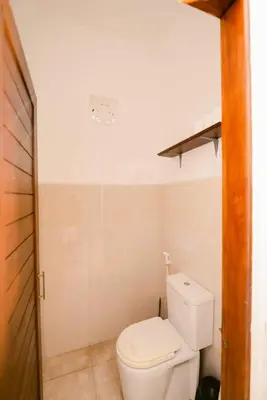 a bathroom with a white toilet in a room at Amazing 2 Bedroom Villa 5 Min To The Beach - Durna Villa in Canggu
