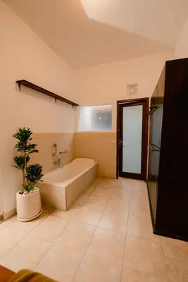 a bathroom with a tub and a plant in it at Amazing 2 Bedroom Villa 5 Min To The Beach - Durna Villa in Canggu