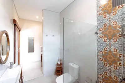 a bathroom with a shower and a toilet and a sink at Villa Shantia by Bby Diamond in Legian