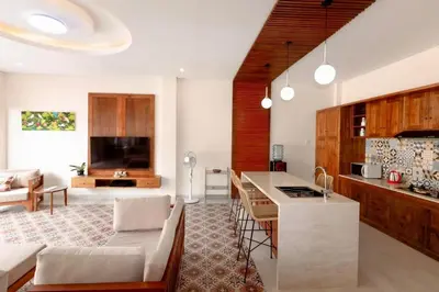 a kitchen and living room with a couch and a table at Villa Shantia by Bby Diamond in Legian