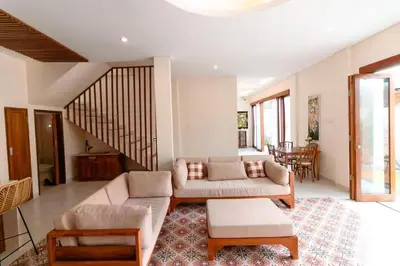 a living room with a couch and a table at Villa Shantia by Bby Diamond in Legian
