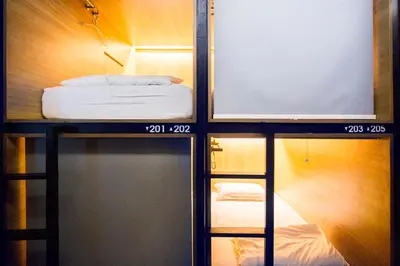 a room with a bed on a shelf and a mirror at M Boutique Hostel in Seminyak