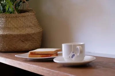 a sandwich and a cup of coffee on a table at M Boutique Hostel in Seminyak
