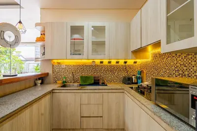 a kitchen with wooden cabinets and a counter top at Villa Naga, pool, Kitchen, terace and garden in Kerobokan