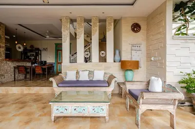 a living room with two couches and a table at Villa Naga, pool, Kitchen, terace and garden in Kerobokan