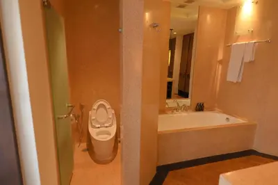 a bathroom with a toilet and a sink and a tub at 1BR Suite Ocean View in Seminyak