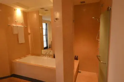 a bathroom with a tub and a sink and a mirror at 1BR Suite Ocean View in Seminyak