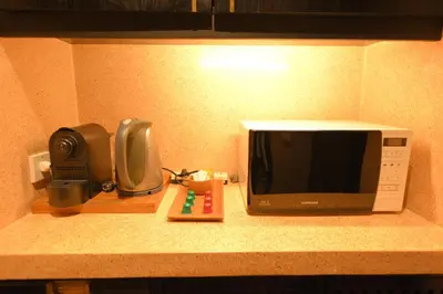 a microwave sitting on a kitchen counter next to a radio at 1BR Suite Ocean View in Seminyak