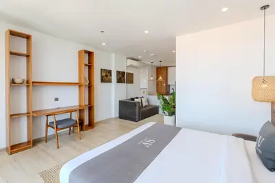 a bedroom with a bed and a living room at Sunny Aparts 2 in Canggu