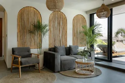 a living room with a couch and two chairs at Sunny Aparts 2 in Canggu