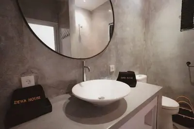 a bathroom with a white sink and a mirror at Elegant 5 Bdr villa in the heart of Seminyak in Seminyak