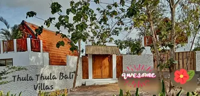 a house with a sign in front of it at Thula Thula Bali Villas in Kerobokan