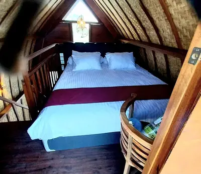 a bedroom with a bed in a attic at Thula Thula Bali Villas in Kerobokan