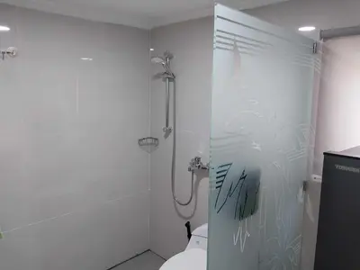 a bathroom with a shower and a toilet at Thula Thula Bali Villas in Kerobokan