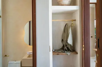 a bathroom with a toilet and a mirror at Casa Admire Villas in Legian