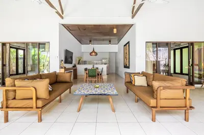 a living room with couches and a table at Villa Amaro Seminyak in Seminyak