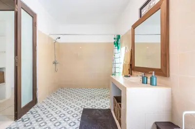 a bathroom with a sink and a mirror at Villa Amaro Seminyak in Seminyak