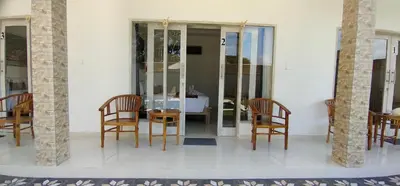 a dining room with chairs and a table and a room at The Lebak Sari Guesthouse in Umalas