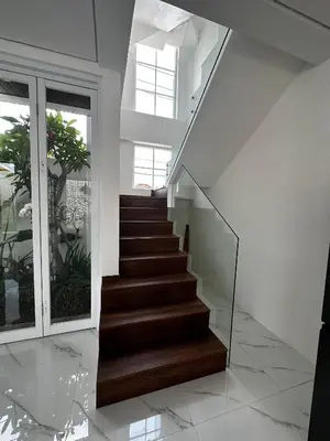 a staircase in a house with glass railing at newly built Villa Na Bali in Seminyak