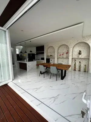a kitchen and dining room with a marble floor at newly built Villa Na Bali in Seminyak