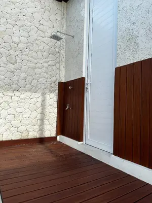 an open door to a room with a wooden deck at newly built Villa Na Bali in Seminyak