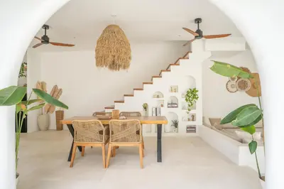 a dining room with a table and chairs at Villa Bohemian Seminyak in Seminyak