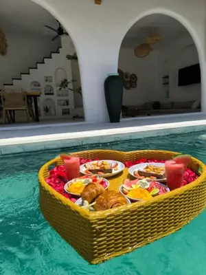 a tray of food in a swimming pool at Villa Bohemian Seminyak in Seminyak