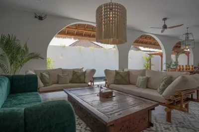 a living room with couches and a coffee table at Villa Rhapsody Seminyak in Seminyak