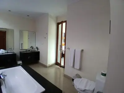 a bathroom with a large bath tub and a sink at Villa Putri in Seminyak Bali in Seminyak