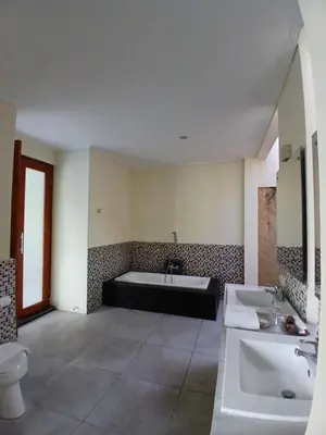 a bathroom with a tub and a sink and a toilet at Villa Putri in Seminyak Bali in Seminyak