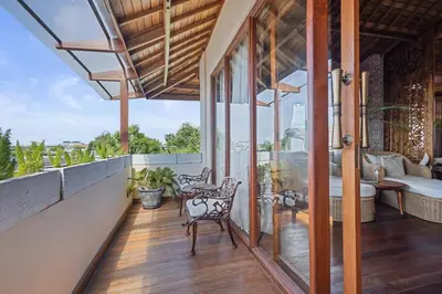 an outdoor balcony with chairs and a view of the ocean at Luxurious Arakana Villa with Pool in Jimbaran