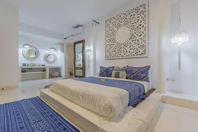 a white bedroom with a large bed with a blue blanket at 3 bedr Mediterranean vibes private pool 5min beach in Seminyak