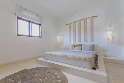 a white bedroom with a large bed and a window at 3 bedr Mediterranean vibes private pool 5min beach in Seminyak