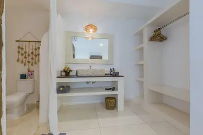 a bathroom with a sink and a toilet and a mirror at 3 bedr Mediterranean vibes private pool 5min beach in Seminyak