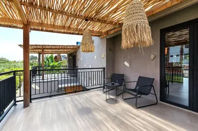 a patio with two chairs and a table on a balcony at Atelier 1Br Villas in Seminyak in Seminyak