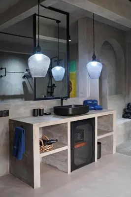a kitchen with two pendant lights and a fireplace at Atelier 1Br Villas in Seminyak in Seminyak