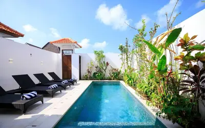 a swimming pool in a backyard with chairs and a house at Gorgeous 2 Bed Pool Villa, Walk to Seminyak Beach in Seminyak