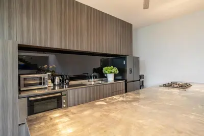 a kitchen with stainless steel appliances and a counter top at Villa Simpatico Spacious 6 BR Villa Retreat in Central Seminyak in Seminyak