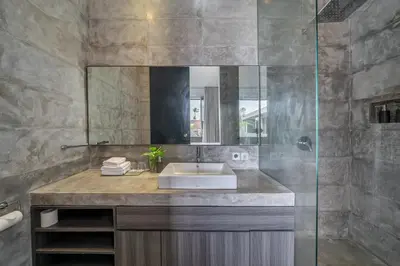 a bathroom with a sink and a mirror at Villa Simpatico Spacious 6 BR Villa Retreat in Central Seminyak in Seminyak